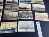many old photos of ships on display on the table