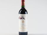 a bottle of red wine sitting on top of a white table