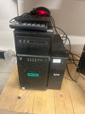 a computer tower that has a mouse on top of it