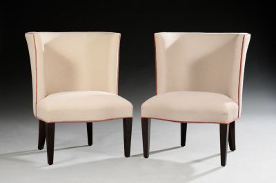 pair of upholstered chairs with red piping on the back