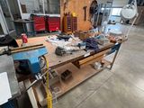 a workbench in the middle of a room with many tools on it