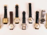 several different types of watches are lined up on a white surface