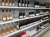 many bottles of wine on the shelves in the store