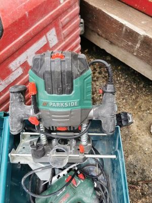 a green and black electric drill in a blue box