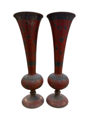 pair of red vases sitting on top of each other on a white surface