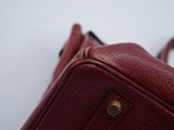 a red purse that is sitting on top of a table