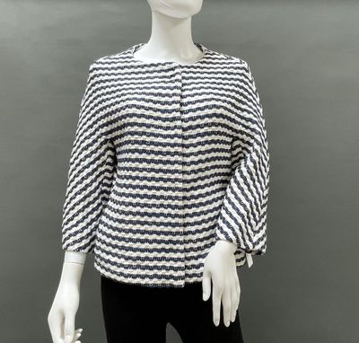a mannequin wearing a black and white top and black pants