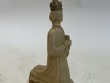 a small statue of a woman with a flower in her hand