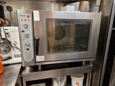 a microwave that is sitting on a shelf in a kitchen