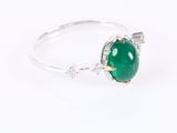 a close up view of a green jade ring on a white background