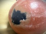 a close up of a vase with a black spot on it