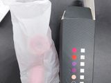 a bag of cotton balls next to a computer keyboard on a desk