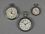 three different types of pocket watches are displayed on a gray surface