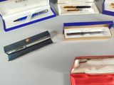 a lot of pens that are sitting in a box