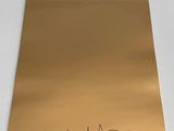signed autographed photo of a gold notebook with a signature of a man