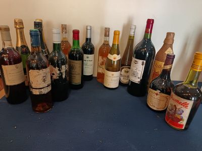 bottles of wine are lined up on a blue counter top