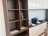 a kitchen with a counter and a book shelf in it