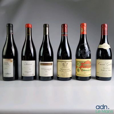 several bottles of wine are lined up in a row on a table