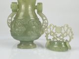 two green vases sitting next to each other on a table