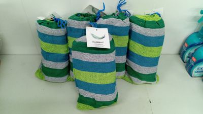 several rolls of towels are lined up on a shelf