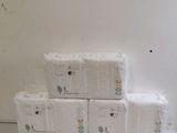 boxes of toilet paper stacked on top of each other in a room