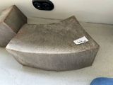 a seat that has a label on it in the corner of a room