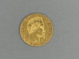 a close up of a gold coin with a woman ' s face on it