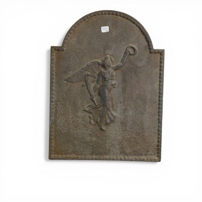 a statue of an angel on a plaque on the wall