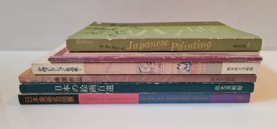 five books stacked on top of each other on a table