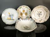 several different types of plates and bowls on a black surface