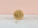 a gold coin sitting on top of a marble counter