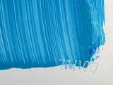a blue painting on a white wall with a blue brush