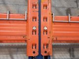 a large orange and blue rack in a warehouse