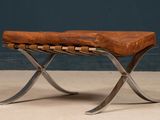 an image of a wooden bench with metal legs and a leather seat