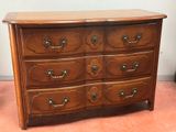 a wooden dresser with many drawers and knobs on it