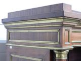 a wooden desk with a gold trim around the top of it