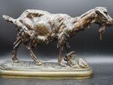 statue of a goat with a fish in it ' s mouth