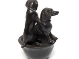 statue of a woman and a dog in a bowl on a white background