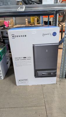 a box that is sitting on the floor in front of a shelf
