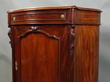 an old wooden cabinet with a door and a drawer on top of it