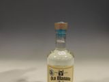 a small bottle of alcohol sitting on a table