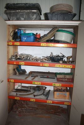 many shelves with tools on them in a room
