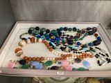 a tray that has many different colored beads on it