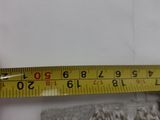 a measuring tape that is on top of a piece of fabric