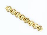 an image of a close up of a gold bracelet on a white surface