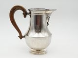 an antique silver coffee pot with a wooden handle on a white background