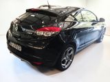 a black car that is parked in a white room