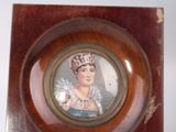 a picture of a picture of a woman in a crown on a plate