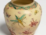 a small vase with a dragonfly painted on it