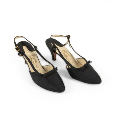 a pair of black high heeled shoes on a white background